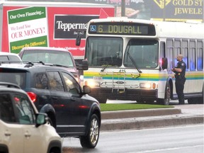 Windsor Police speak with the driver of a Transit Windsor bus after an incident with a red Ford pickup truck on the northbound lanes of Ouellette Avenue at Ouellette Place Wednesday during evening rush hour.