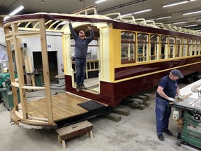 RM Auto Restoration craftsmen Jamie Bourdeau and Serge Legare, right, work on  Streetcar No.351 in Chatham-Kent.  Bourdeau and Lagare have reconstructed thousands of parts mostly in ash, with cherrywood used around the windows.  A 36-foot, 6-inch roof header board made out of fir was cleaned up and put back into service on one side.  An original controller, brake switch and conductor's seat will be mounted in one of the vestibles, much like when Streetcar No.351 rumbled along the tracks in Windsor in the years before 1939.