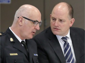 Windsor police Chief Al Frederick, left, speaks with Windsor Mayor Drew Dilkens during a community meeting in 2018.