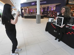 The Bulimia Anorexia Nervosa Association marked Eating Disorder Awareness Week by launching a Positive Body Image Pledge Campaign at the Devonshire Mall on February 2, 2019. Morgan Carter, left, a nursing intern with the organization, snaps a photo of Luciana Rosu-Sieza, BANA executive director, during the event