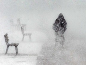 Blowing snow obscures a cyclist in downtown Windsor in this February 2016 file photo.