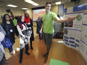 Liam LeClair, right, a third year biomedical student at the University of Windsor speaks to local high school students during the Let's Talk Cancer Symposium on Thursday, February 21, 2019, at the University of Windsor.