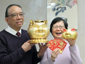 Stephen Tsui, president of the Essex County Chinese Canadian Association, and Maggie Yip, ECCCA treasurer, hold up Chinese New Year mementoes. It's the Year of the Pig as of Tuesday, Feb. 5, 2019.