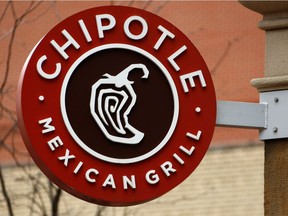 FILE- This Jan. 12, 2017, file photo shows the sign on a Chipotle restaurant in Pittsburgh. Chipotle is teaming up with Oscar-winning documentary filmmaker Errol Morris for a series of ads touting its fresh ingredients.