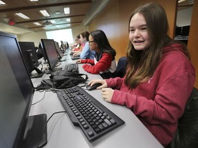Ardyn Tomkins, 13, right, and other young girls participate in a computer programming workshop on Saturday, February 9, 2019, at the University of Windsor.