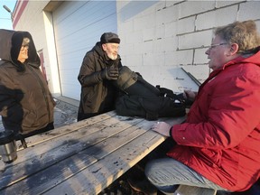 Supporters of The Windsor Residence for Young Men including volunteer Mary Lynne Lafontaine, executive director Greg Goulin, who is celebrating his 70th birthday out in the cold  and board member Brian Worrall prepare Friday to spend their night outside as part of the the Coldest Night Out event in a parking lot in the 1300 block of St. Luke Road. Participants in the fundraiser committed to staying outdoors from 5 p.m. to 7 a.m.