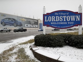 FILE- In this Nov. 27, 2018, file photo a banner depicting the Chevrolet Cruze model vehicle is displayed at the General Motors' Lordstown plant in Lordstown, Ohio. General Motors reports financial results Wednesday, Feb. 6, 2019.