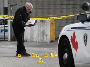 An investigator with the Special Investigations Unit is shown on the scene near the McDonald's at Goyeau and Wyandottte on Wednesday, March 21, 2018, in Windsor. Matthew Mahoney was fatally shot by police after he attacked officers with a knife.