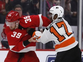 Detroit Red Wings right wing Anthony Mantha (39) and Philadelphia Flyers right wing Wayne Simmonds (17) fight during the first period of an NHL hockey game, Sunday, Feb. 17, 2019, in Detroit.