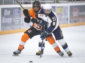 Amherstburg's Cory Burns and Essex' Quinn Fazekas battle for the puck during Tuesday's Bill Stobbs Division semifinal opener at the Essex Centre Sports Complex in the Provincial Junior Hockey League.