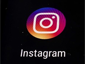 FILE  - In this Thursday, Nov. 29, 2018 file photo, the Instagram app logo is displayed on a mobile screen in Los Angeles. Instagram has agreed to ban graphic images of self-harm after objections were raised in Britain following the suicide of a teen whose father said the photo-sharing platform had contributed to her decision to take her own life.