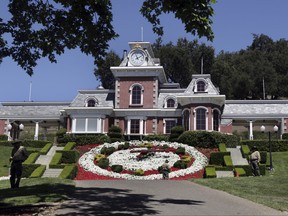 In this July 2, 2009, file photo, workers standby at the train station at Neverland Ranch in Los Olivos, Calif. Michael Jackson's former home has been renamed Sycamore Valley Ranch. (AP Photo/Carolyn Kaster, File)