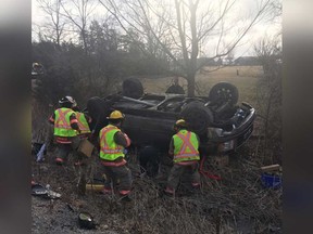 Firefighters and OPP officers work at the scene of a single-vehicle rollover on Highway 3 near Kingsville on the morning of Feb. 25, 2019.