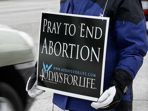 A placard carried by an anti-abortion protester on Tecumseh Road East near Windsor Regional Hospital's Met Campus in April 2011.