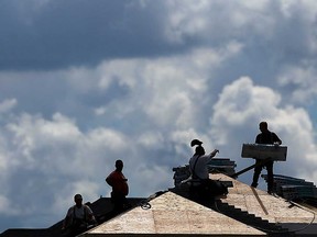 Roofers on a job in Windsor in August 2016.