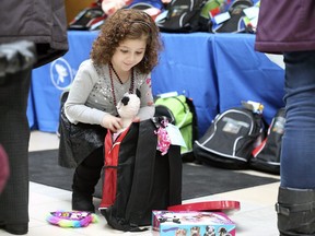 The Transition to Betterness (T2B) and the Stephanie and Barry Zekelman Foundation delivered toy-filled backpacks to the pediatric patients at the Windsor Regional Hospital on Wednesday, February 13, 2019.  Rabab Ozeir, 5, checks out some of the items in a backpack during the event.