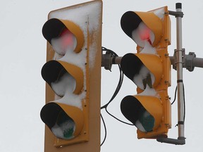 Snow-covered traffic signals at an intersection in south Windsor are shown in this February 2016 file photo.