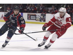 Windsor Spitfires' defenceman Nathan Staios, left, battles Sault Ste. Marie's Jordan Sambrook for the puck.