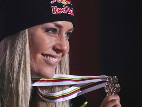 Third placed United States' Lindsey Vonn poses during the medal ceremony for the women's downhill race at the alpine ski World Championships in Are, Sweden, Sunday, Feb.10, 2019.