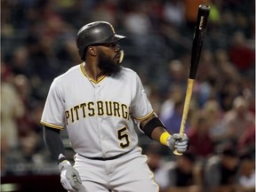 In this June 11, 2018, file photo, Pittsburgh Pirates' Josh Harrison bats against the Arizona Diamondbacks at a baseball game in Phoenix. The new Detroit Tigers second baseman could earn millions this year.