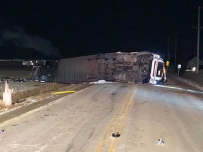 A transport truck lies on its side after a collision with another tractor trailer on Highway 77 north of Leamington on the night of Feb. 19, 2019.