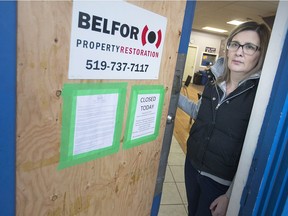 Crystal Fach, family support at W.E. Trans Support, stands next to their damaged front door at 111 Wyandotte St. West, Wednesday, February 20, 2019, after an early morning break-in.