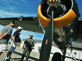 File Photo/The Daily News John Koekuyt, second from left, speaks with Rex Kanitz, right, underneath the wing of a Yankee Warrior B-25D "Mitchell" Bomber during the Chatham-Kent Flight Fest at the Chatham-Kent Municipal Airport July 23, 2016.