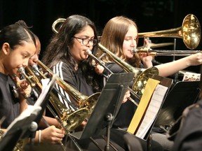 West Gate Academy band members Nanza Bedi, centre, and Erisa Dalipi, right, and other brass section musicians perform one of three arrangements during MusicFest Windsor at Capitol Theatre Monday.  Jazz and concert bands from local schools performed and were judged, then offered constructive criticism. West Gate Academy band was lead by conductor Keith Williamson.