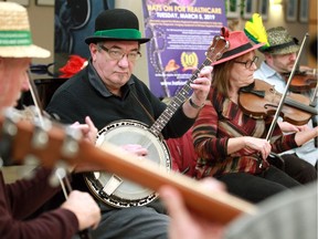 Les Morvay on the bango and Susan Tracey, right, on the fiddle, play Irish tunes with other members of the Clare Session group during a Hats On for Healthcare fundraising event at Windsor Regional Hospital's Met Campus.