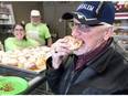Ken Heuston, 76, bites into a 'lowczki' at Nana's Bakery on Dominion Boulevard, Tuesday March 5, 2019.  Bakery owners Barb and Doug Romanek, behind right, created their version of the paczki, which are lower in fat and calories.  Heuston has purchased dozens of the original paczkis when living in Milwaukee, Wisconsin, but they were eaten so fast he never tasted one until Tuesday at Nana's Bakery.