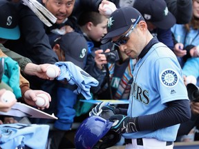 Ichiro Suzuki of the Seattle Mariners signs autographs for fans before the MLB spring training game against the Oakland Athletics at Peoria Stadium on Feb. 22, 2019 in Peoria, Arizona.