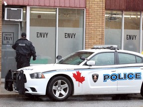 A Windsor police officer at Envy — an allegedly illegal cannabis store in the 300 block of University Avenue West. Photographed March 14, 2019.