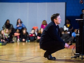 Tech billionaire Elon Musk talks with Flint students on March 22, 2019 at Doyle-Ryder Elementary School in Flint, Mich. The Elon Musk Foundation announced in December it was giving about $424,000 to help provide laptops as the city recovers from a crisis with lead-tainted water.