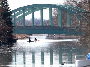 Kayakers paddle on Little River south of Wyandotte Street East bridge on a beautiful spring morning in East Riverside Wednesday.