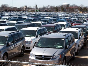 Hundreds of Dodge Grand Caravans and Chrysler Pacificas manufactured by FCA Windsor Assembly Plant are parked on the old GM Transmission Plant property now operated by Motipark Automotive Storage Wednesday.