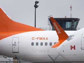 A pair of Sunwing's Boeing 737 Max 8's are parked at the Windsor International Airport, Thursday, March 14, 2019, after the fleet is grounded worldwide.