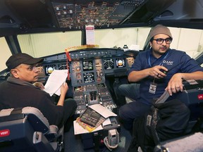 AAR Aircraft Services Windsor avionics engineers Risham Yehiya, left, and Syed Adnan Qadir perform maintenance work in the cockpit of a plane at the Windsor facility on Thursday, March 7, 2019. The company located at the Windsor Airport is looking to expand.