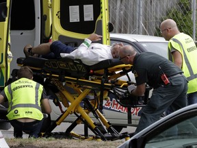 Ambulance staff take a man from outside a mosque in central Christchurch, New Zealand, Friday, March 15, 2019. Multiple people were killed in mass shootings at two mosques full of worshippers attending Friday prayers on what the prime minister called "one of New Zealand's darkest days," as authorities detained four people and defused explosive devices in what appeared to be a carefully planned attack. (AP Photo/Mark Baker) ORG XMIT: XMB102