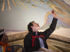 Eric Stewart with Historic Plaster Conservation Services, inspects the ceiling of Assumption Church, Thursday, March 7,  2019.