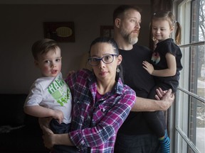 Meg Rigden holds Liam Rigden, 2, who was diagnosed with level 3 autism, while Craig Rigden holds Kieran Rigden Roy, 4, who was diagnosed with level 2 autism, at their home in East Windsor, Thursday, March 21, 2019.