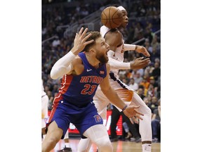 Phoenix Suns forward Richaun Holmes and Detroit Pistons forward Blake Griffin (23) look for the ball during the second half of an NBA basketball game Thursday, March 21, 2019, in Phoenix.