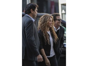 Colombian singers Shakira, center, and Carlos Vives, right, arrive at court in Madrid, Spain, Wednesday, March 27, 2019. Shakira and Vives have previously rejected allegations made by a Cuban-born singer and producer that they had plagiarized his work in their award-winning music hit "La Bicicleta".
