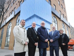 The WindsorEssex Economic Development Corporation will soon move to the old Beer Market and Chatham Street Grill in downtown Windsor. Board member William Willis, left, board chair Tal Czudner, Mayor Drew Dilkens, WEEDC CEO Stephen MacKenzie and director of marketing and communications Lana Drouillard pose in front of the historic corner on Tuesday, March 19, 2019.