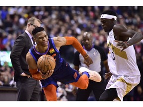 Oklahoma City Thunder guard Russell Westbrook (0) and Toronto Raptors forward Pascal Siakam (43) battle during second half NBA basketball action in Toronto on March 22, 2019.