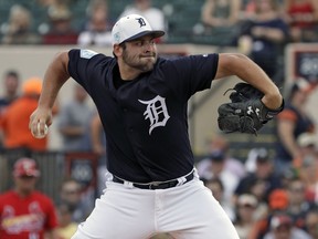 Detroit Tigers starting pitcher Michael Fulmer goes into his windup against the St. Louis Cardinals during the first inning of a spring training baseball game Monday, March 4, 2019, in St. Petersburg, Fla.