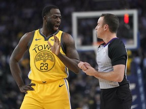 Golden State Warriors forward Draymond Green argues a call with referee Josh Tiven (58) during the first half against the Detroit Pistons in an NBA basketball game Sunday, March 24, 2019, in Oakland, Calif.