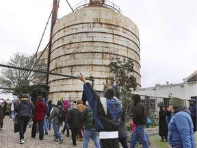 Church Under the Bridge members raise their arms while arriving at the new location at Magnolia Silos, Sunday, March 3, 2019, in Waco, Texas. The group had been meeting under the overpass at Interstate 35 but upcoming construction projects forced them to find the new location. Chip and Joanna Gaines offered them a temporary location at the Magnolia Market at the Silos.