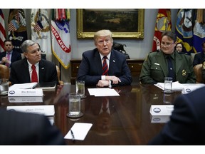 Mike McDaniel, director of Houston High Intensity Drug Trafficking Areas, left, and Carla Provost, chief of the U.S. Border Patrol, right, listen as President Donald Trump speaks in the Roosevelt Room of the White House, Wednesday, March 13, 2019, in Washington. Trump said the U.S. is issuing an emergency order grounding all Boeing 737 Max 8 and Max 9 aircraft "effective immediately," in the wake of the crash of an Ethiopian Airliner that killed 157 people.