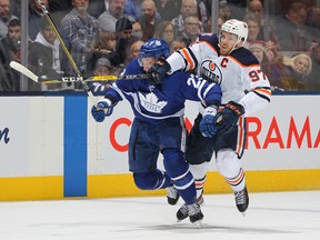 Leafs defenceman Travis Dermott (left) predicts two more practices before he’s back in the lineup. He injured his shoulder during a game against the Oilers last month. (Getty images)