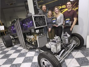 Gord Osborne, a transportation technology teacher at Kingsville District High School along with students Paige Roddy, left, Grace Vermeulen and Alec Tonkin pose with Dragula 2.0 on Tuesday, March 5, 2019, at the Canadian Transportation Museum in Kingsville. The purple coffin dragster is based on a car from the TV show Munsters. The car built by about 80 students under Osborne's guidance won two awards at the Detroit Autorama show.